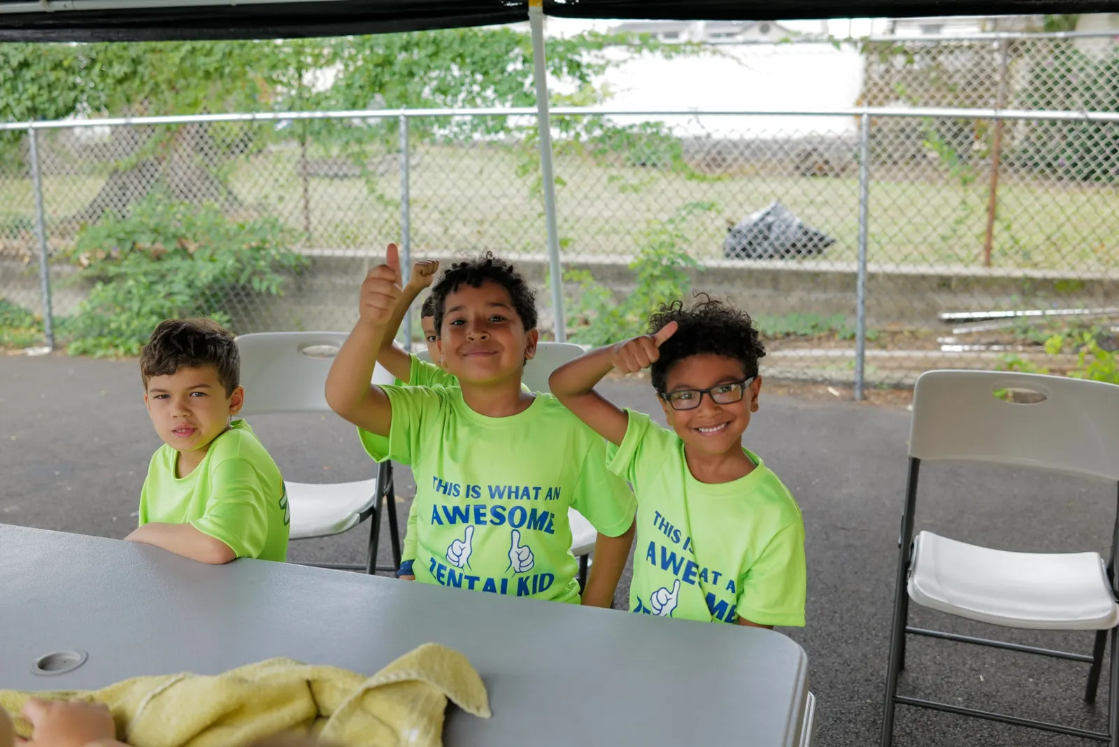 ZENTAI Summer Camp kids thumbs up at table