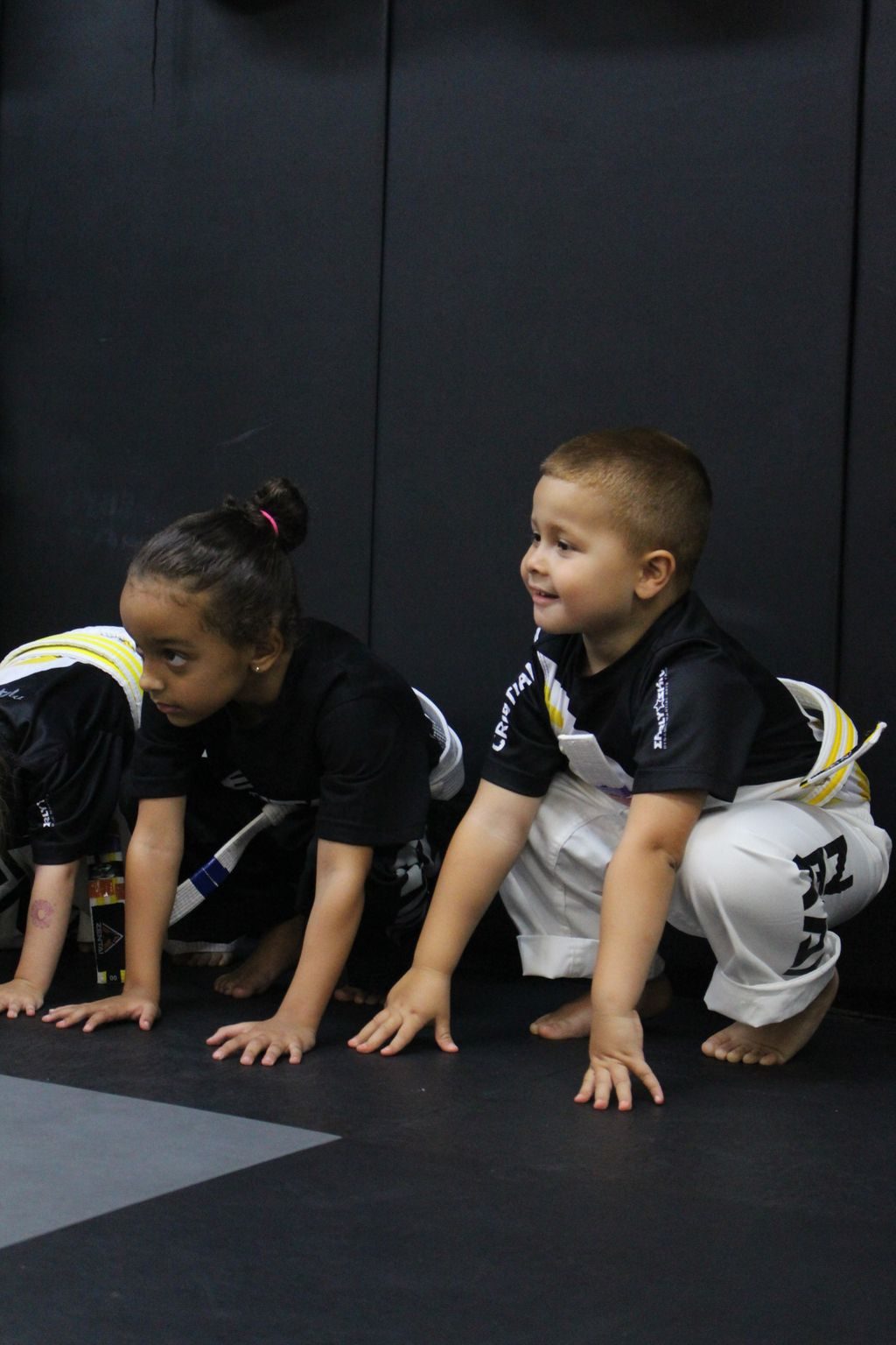 Preschoolers on hands and knees in a line at ZENTAI Martial Arts in North Arlington, NJ