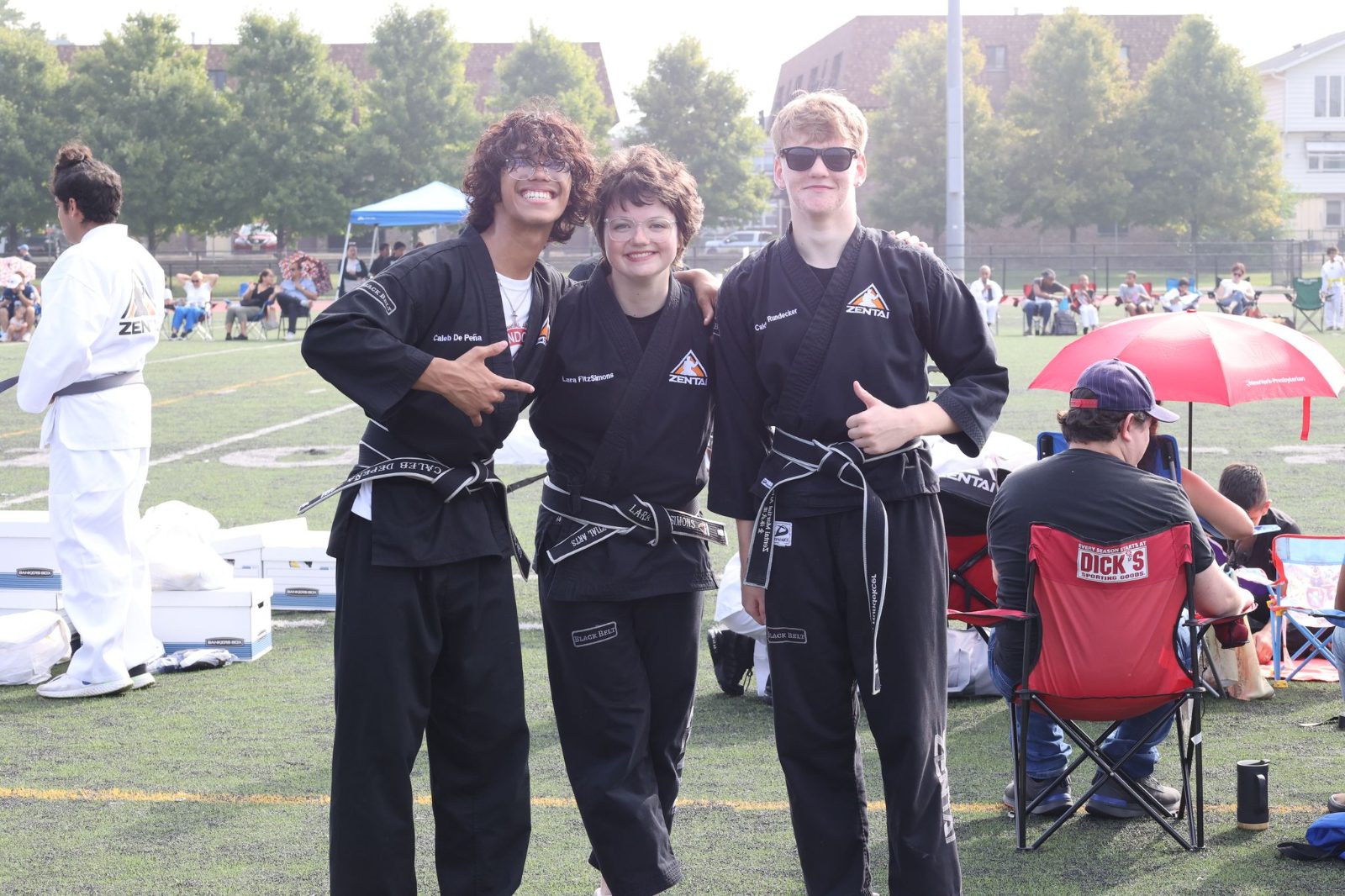 Teen black belts smiling together at a ZENTAI Martial Arts belt promotion in New Jersey