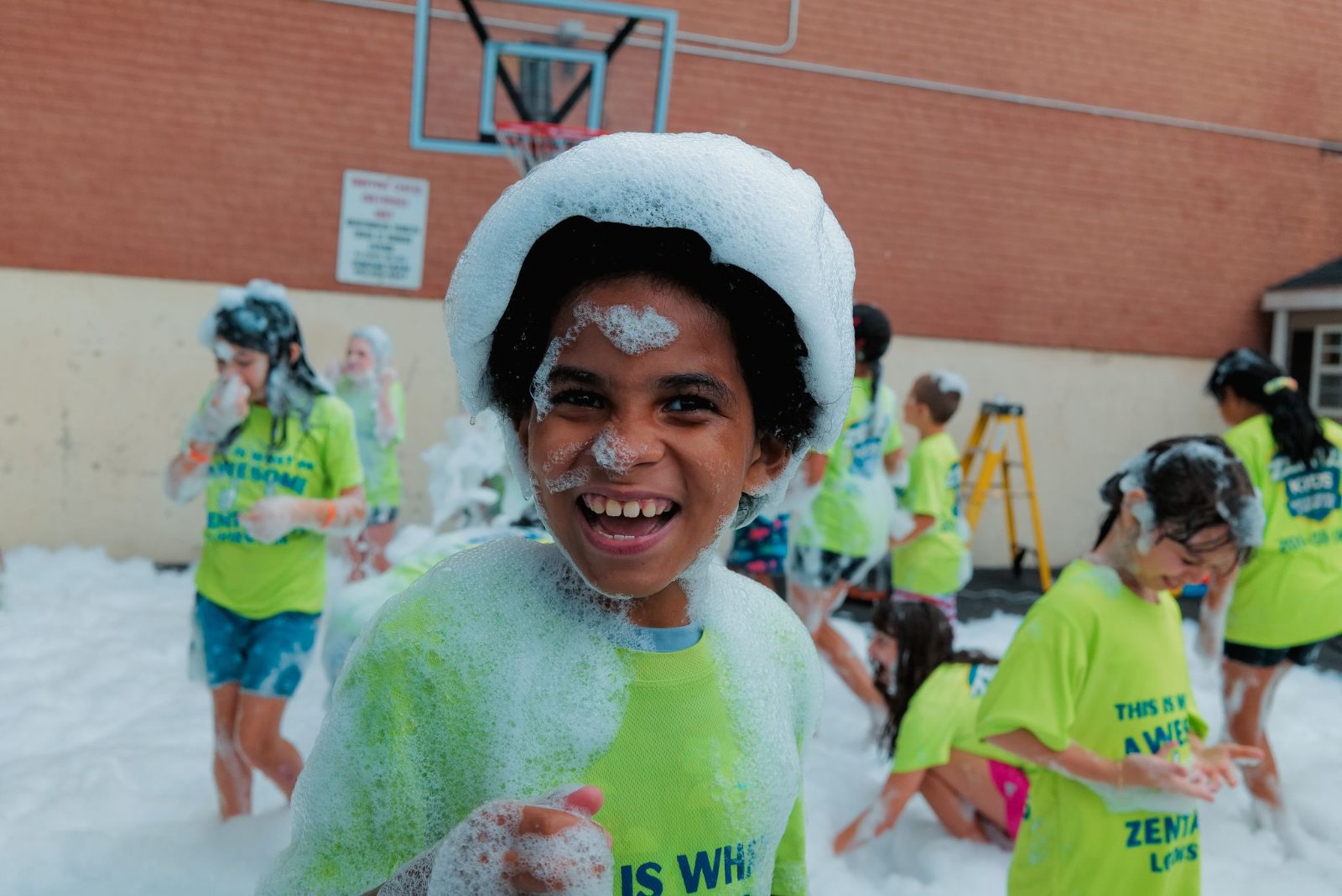 Camper laughing in foam at ZENTAI Martial Arts summer camp in New Jersey