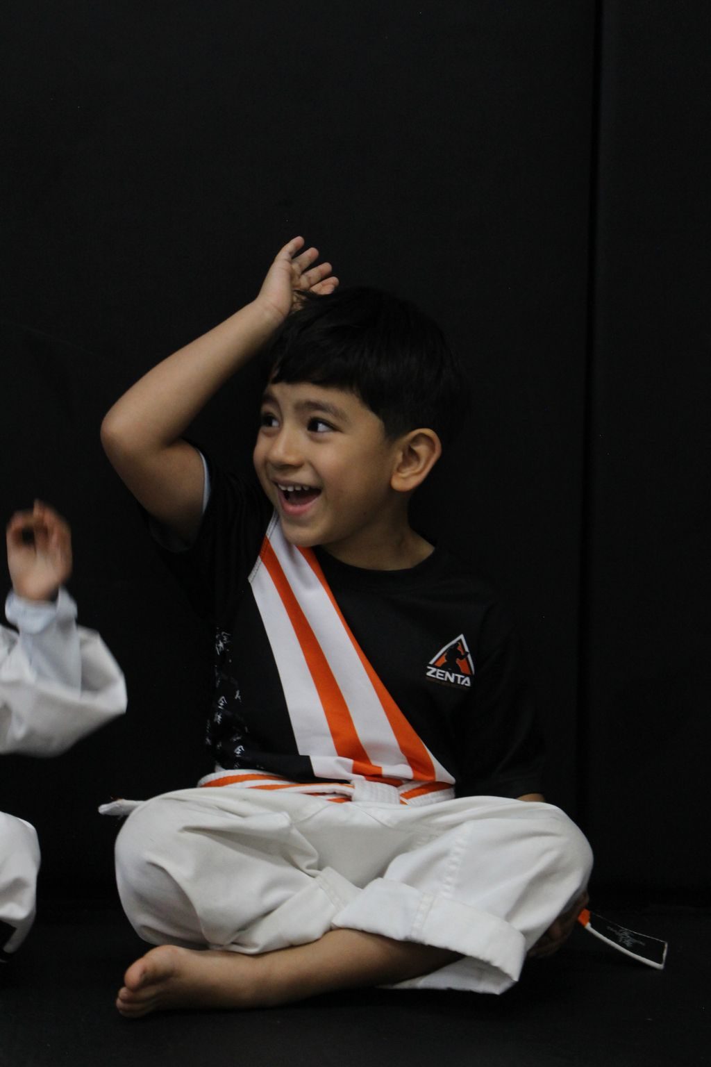 Boy thinking with hand on head at ZENTAI Martial Arts in North Arlington, NJ