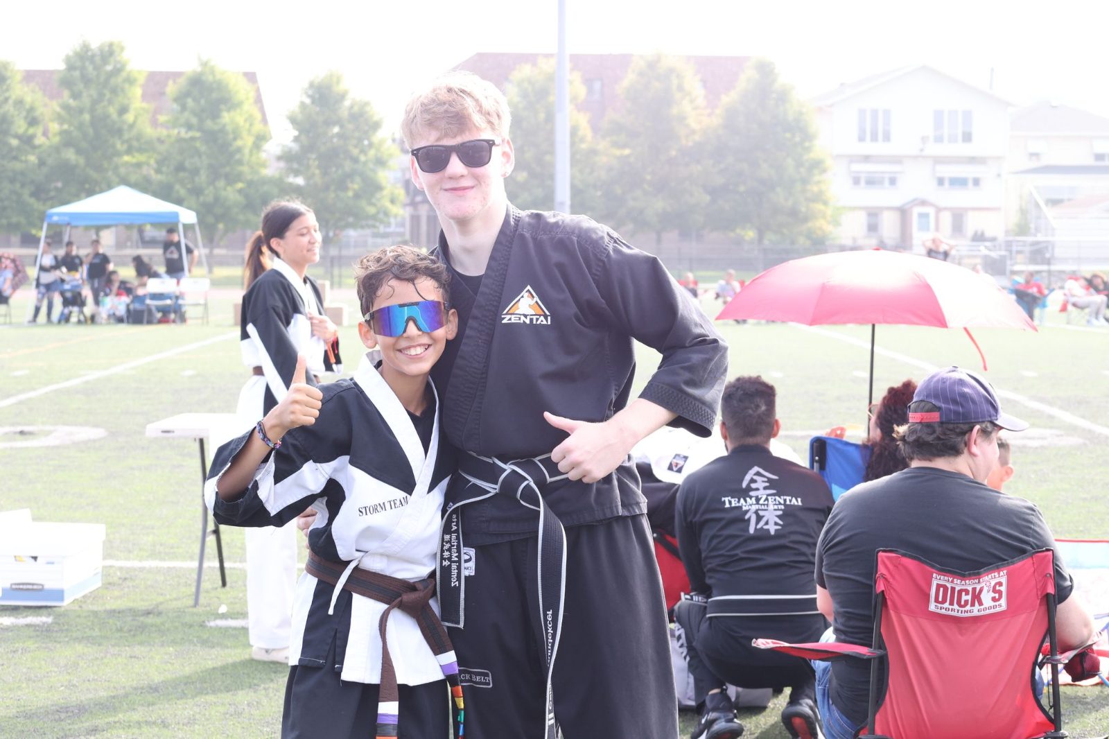 Black belt teens smiling together at a belt promotion in New Jersey