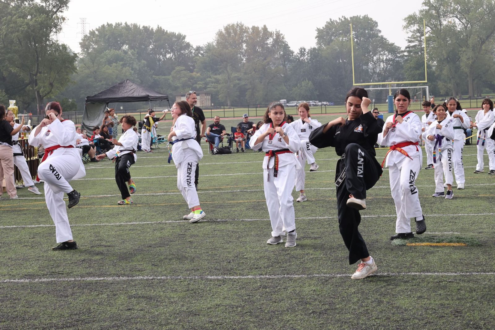A group practicing forms on the field at the ZENTAI Mega Belt Promotion in New Jersey