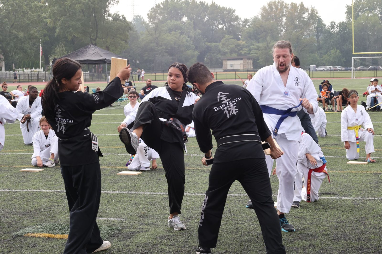 Black belts demonstrating techniques at the ZENTAI Mega Belt Promotion in New Jersey