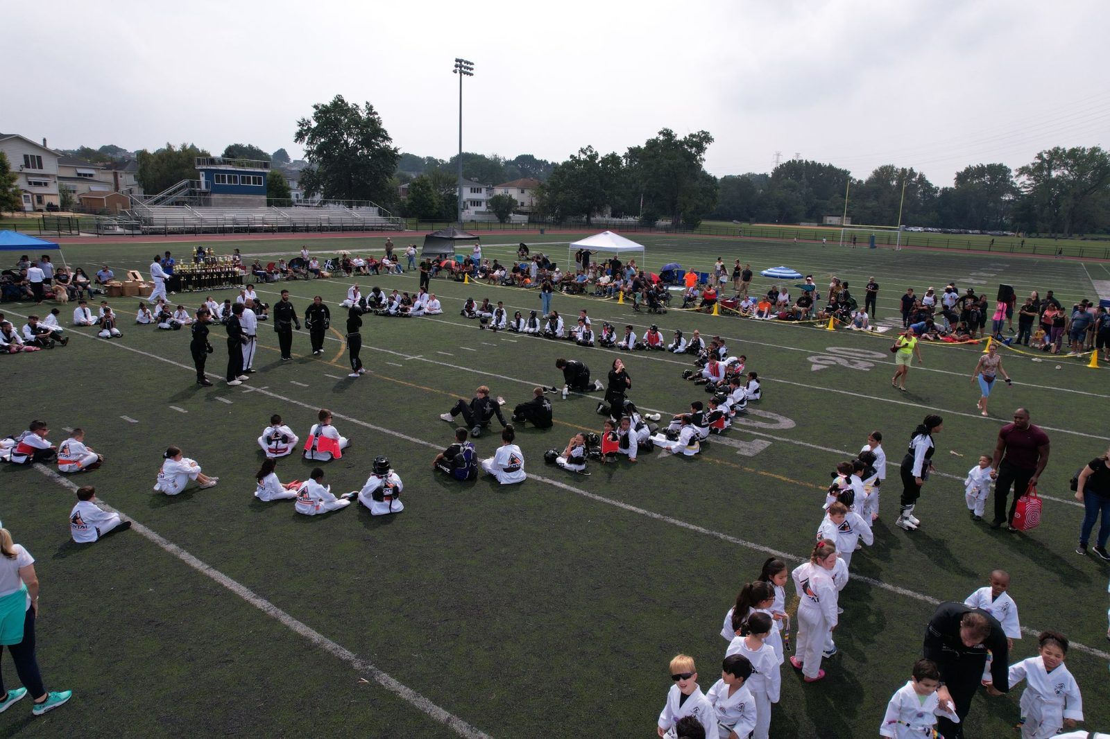 Wide view of student groups around the field at the ZENTAI Mega Belt Promotion in New Jersey