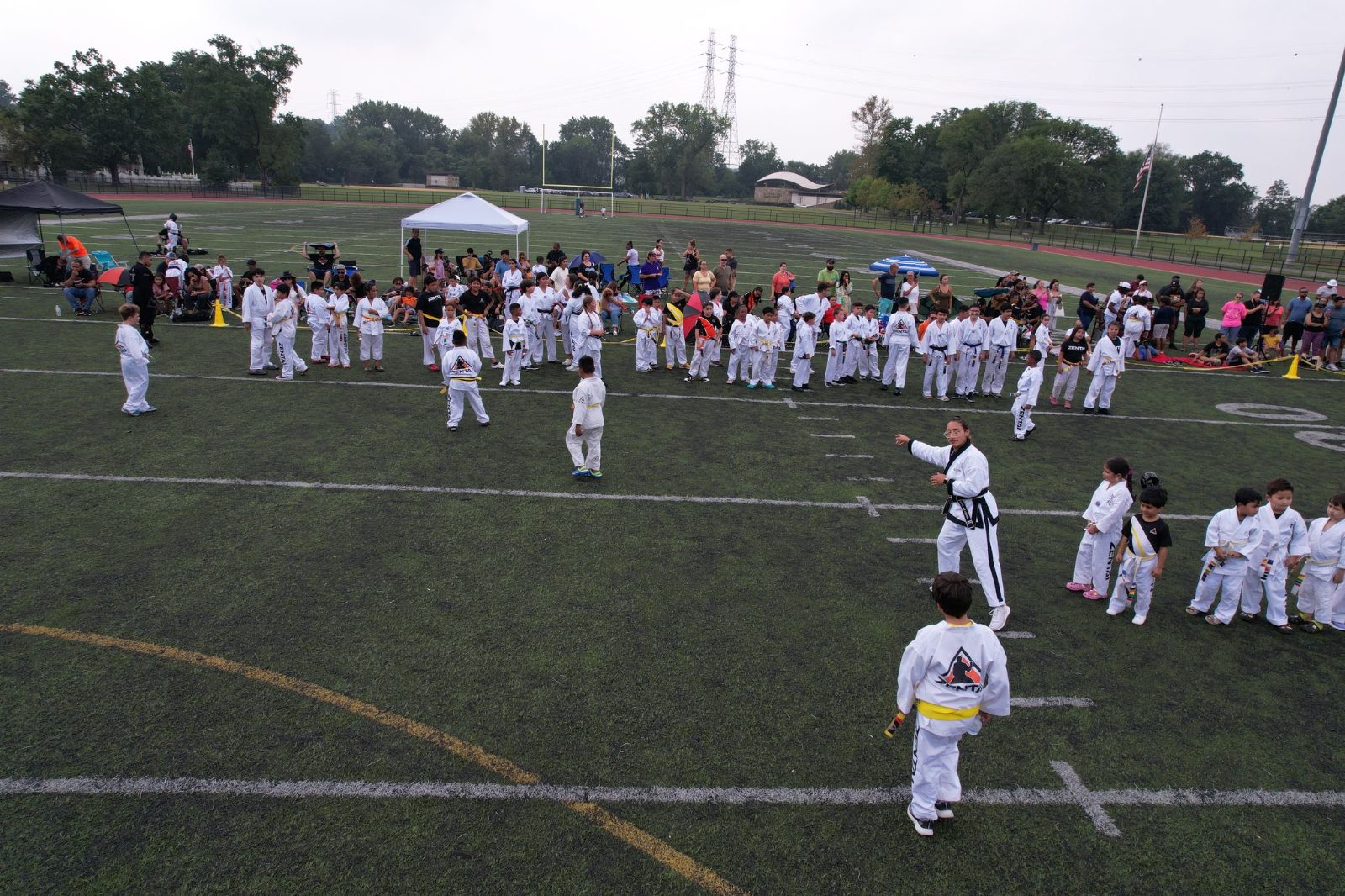 Rows of students training on the field at the ZENTAI Mega Belt Promotion in New Jersey