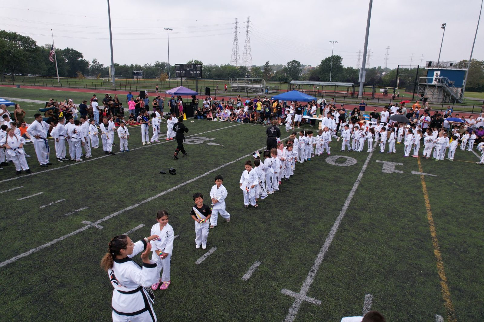 A long line of students on the field at the ZENTAI Mega Belt Promotion in New Jersey