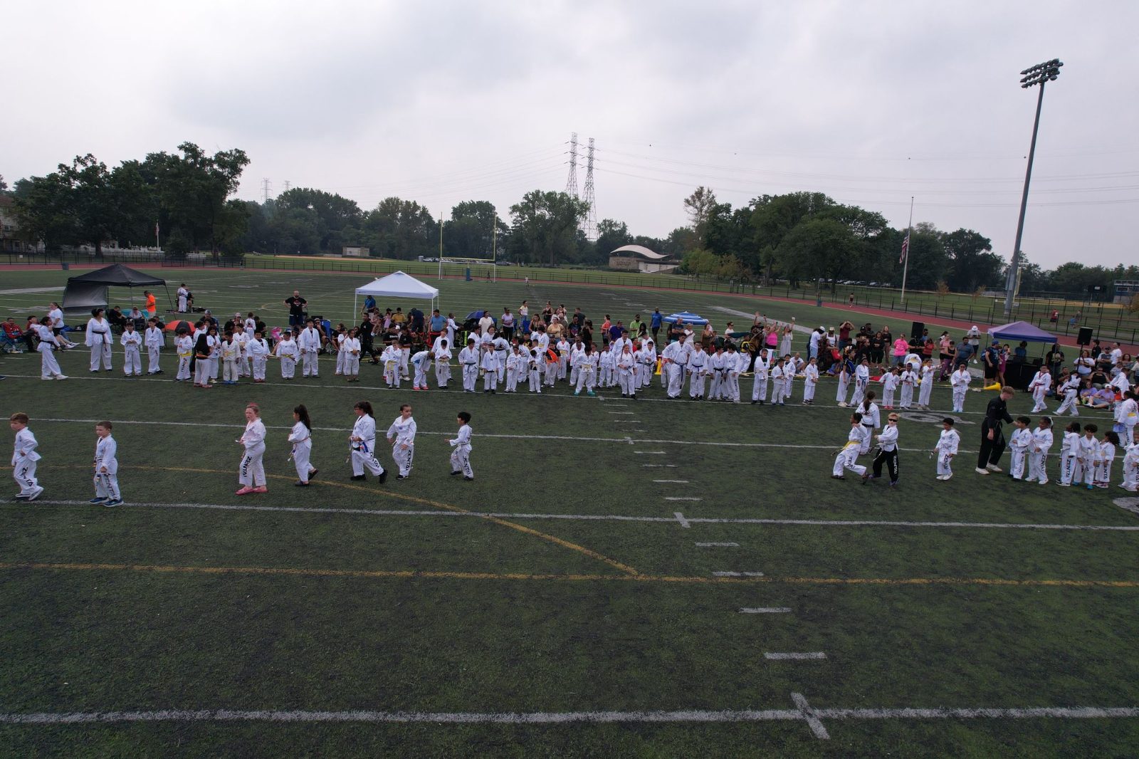 Students spread out training across the field at the ZENTAI Mega Belt Promotion in New Jersey