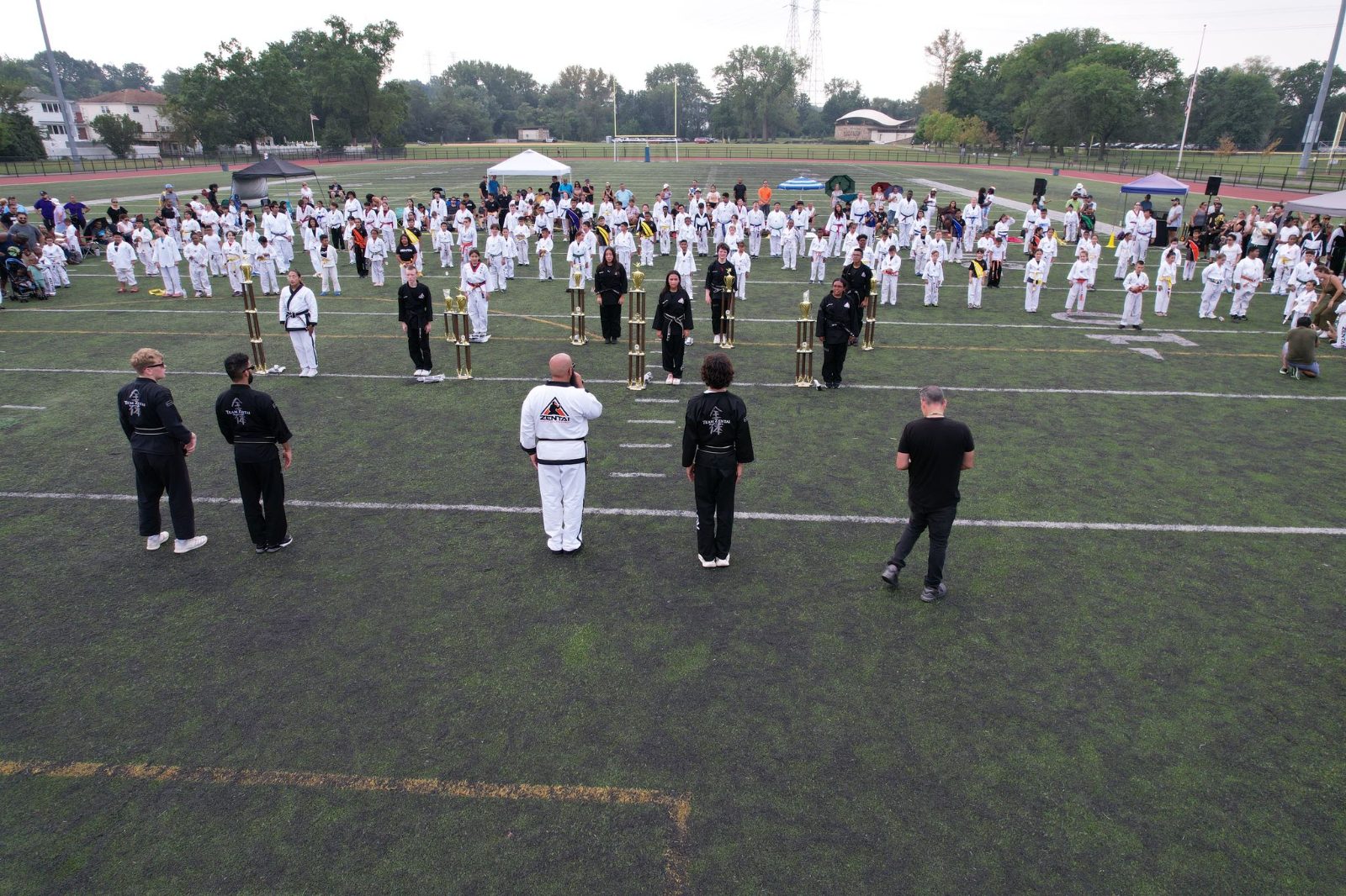 Rows of students in white uniforms at the ZENTAI Mega Belt Promotion in New Jersey
