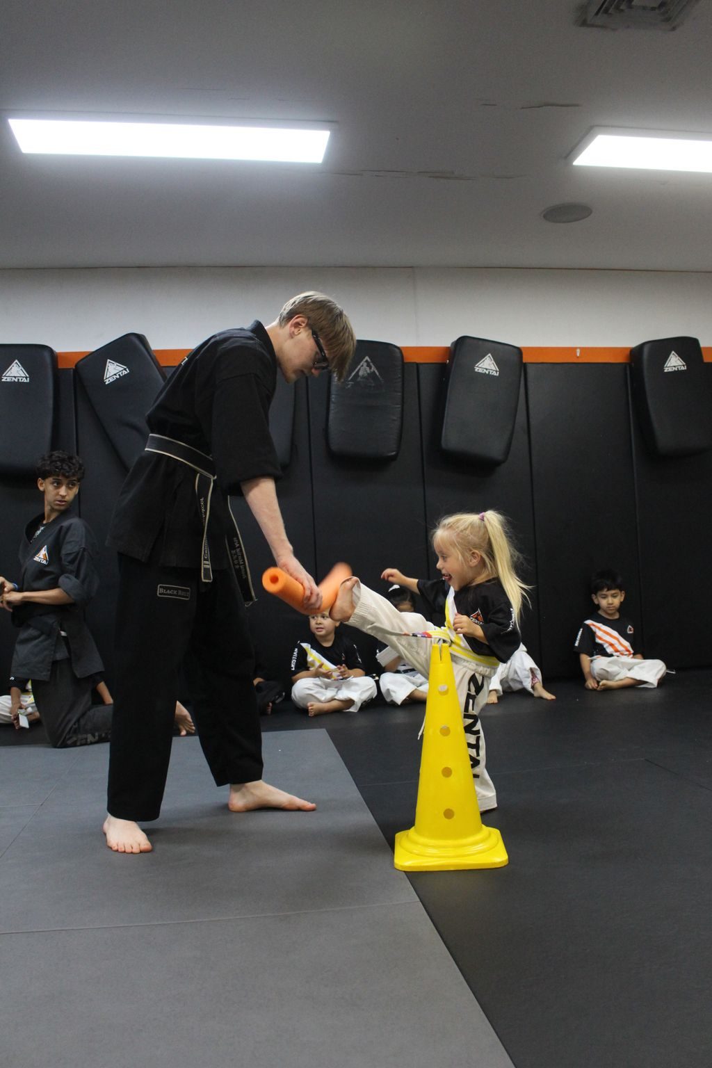 Instructor guiding a young student past cones at ZENTAI Martial Arts in North Arlington, NJ