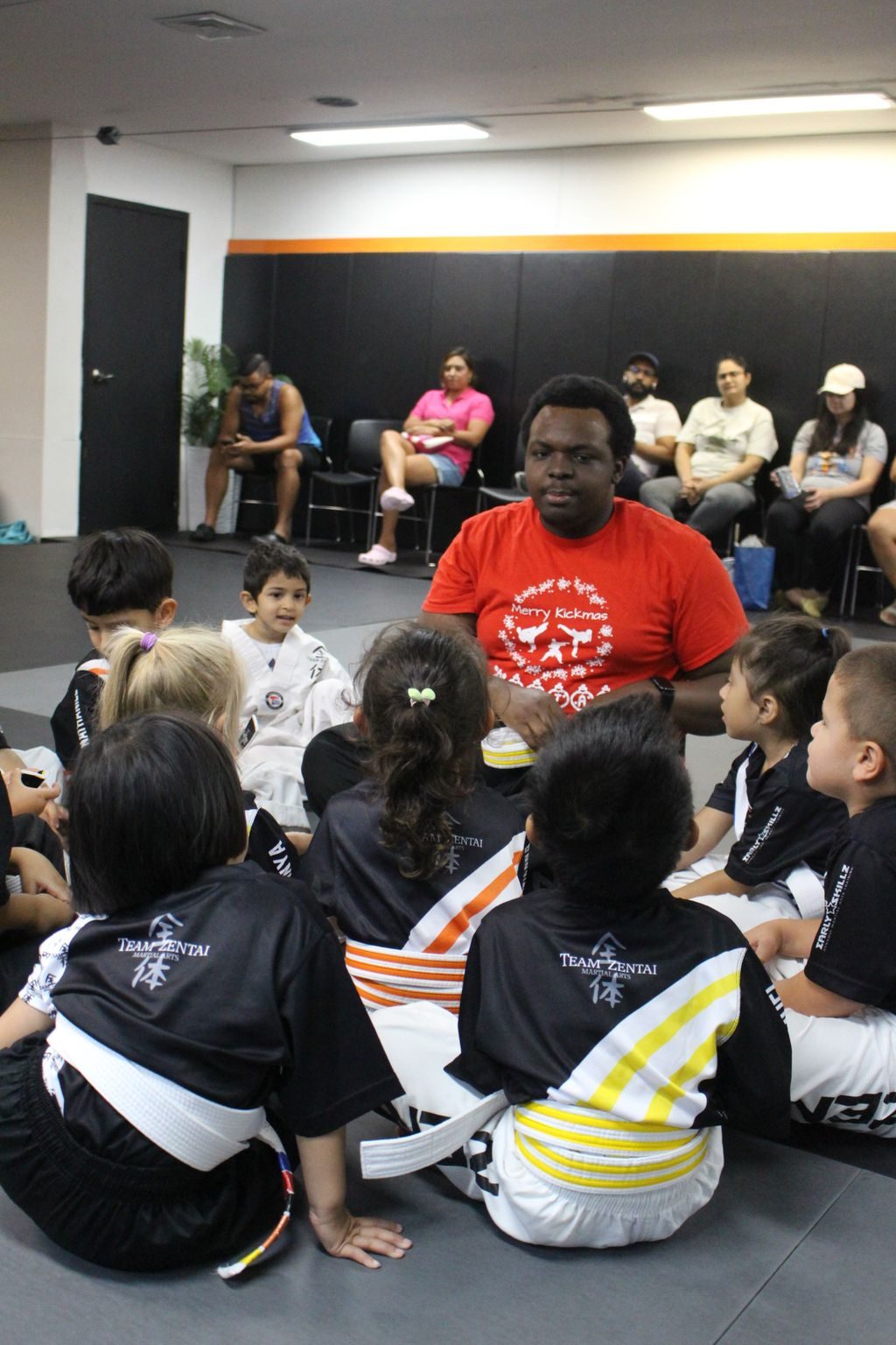 Instructor talking with a group of seated kids at ZENTAI Martial Arts in North Arlington, NJ