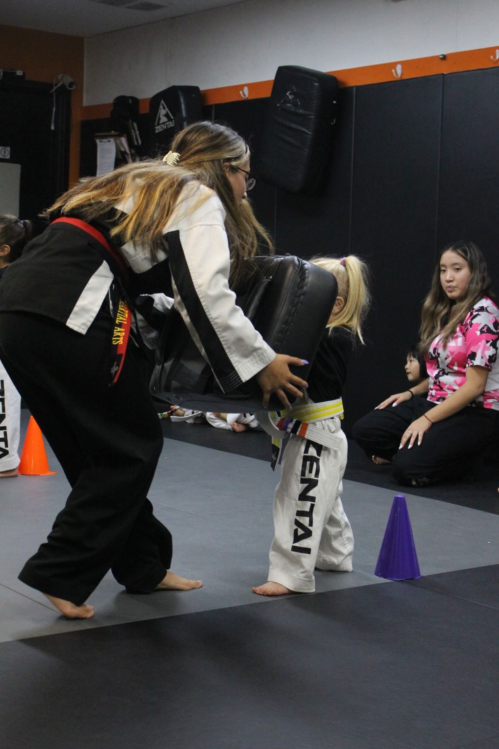 Instructor working with a young student while parents watch at ZENTAI Martial Arts in North Arlington, NJ