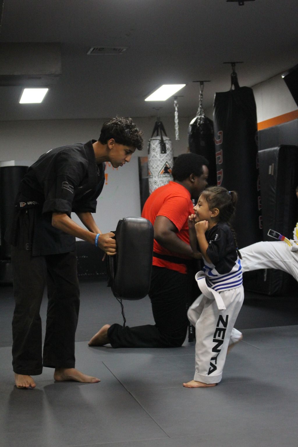 Instructor holding a pad for a young student at ZENTAI Martial Arts in North Arlington, NJ