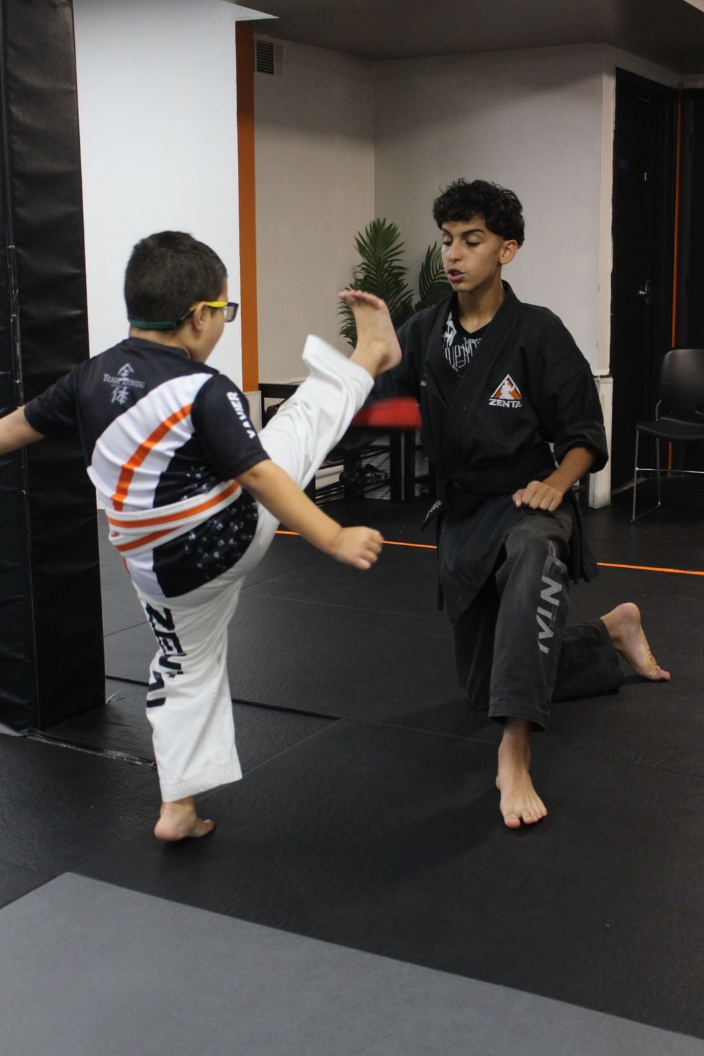 Teen instructor coaching a boy at ZENTAI Martial Arts in North Arlington, NJ
