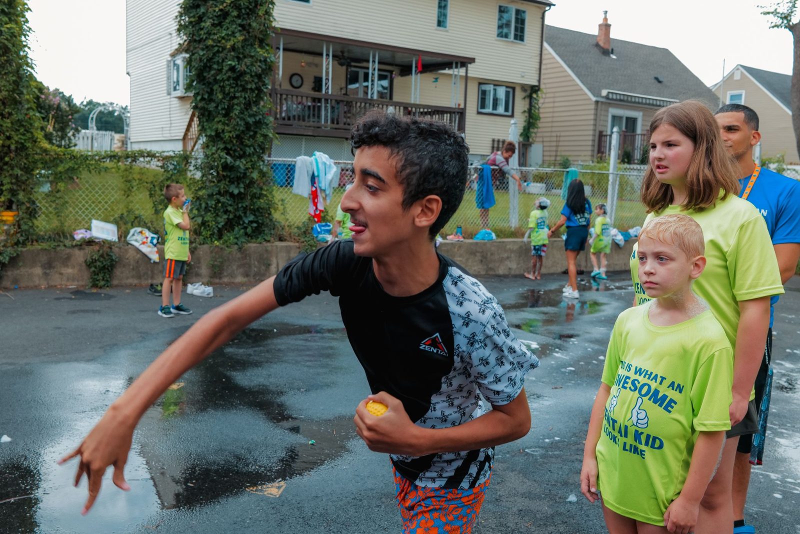 Boy running and splashing outdoors at ZENTAI summer camp in New Jersey