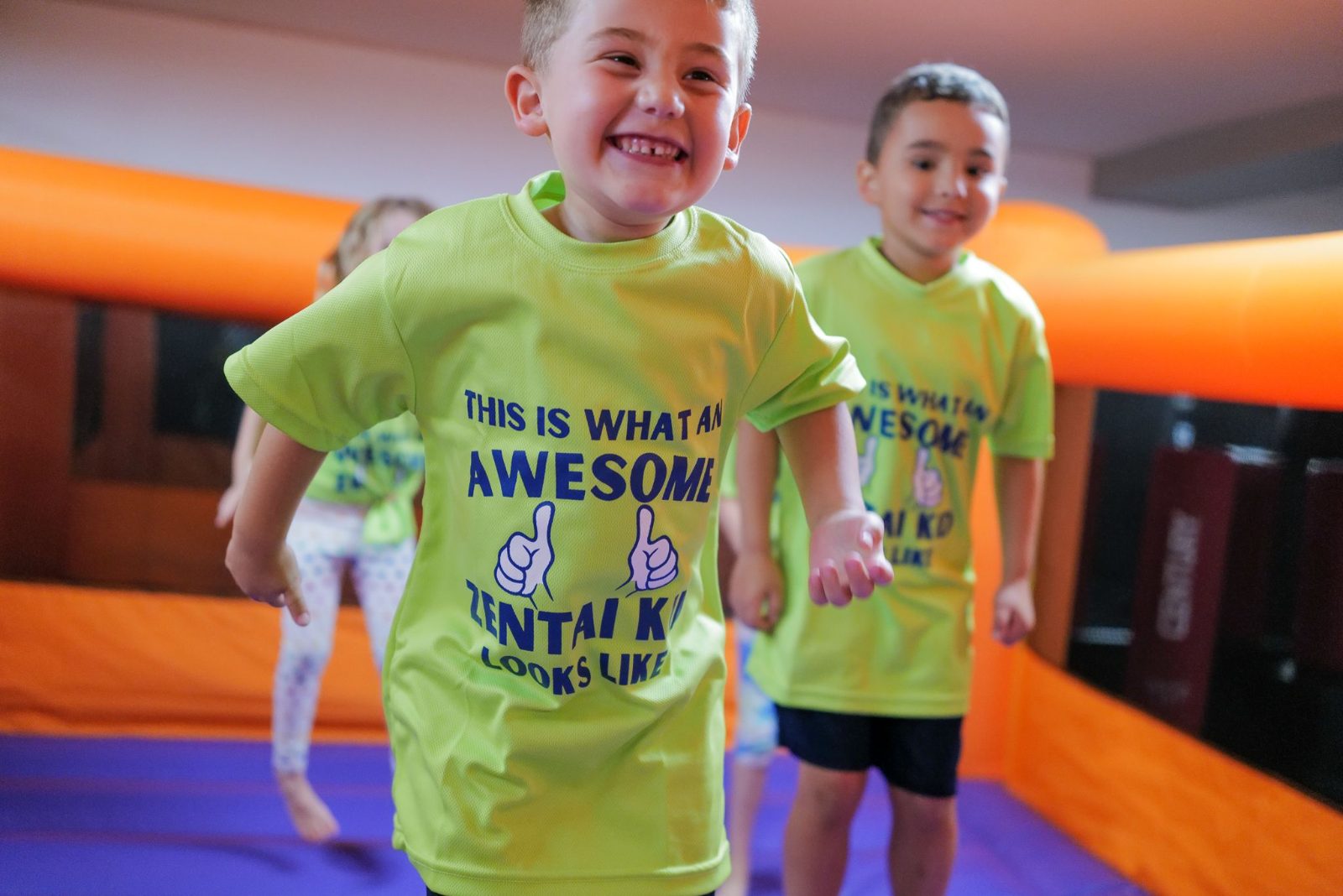 Campers smiling in a bounce house at ZENTAI summer camp in New Jersey