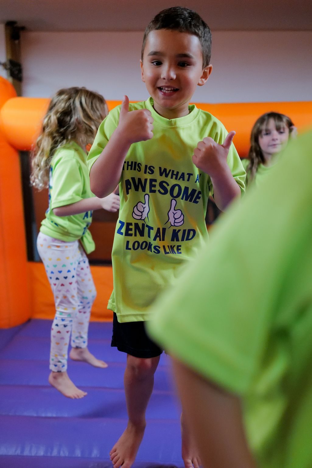 Young camper playing in a bounce house at ZENTAI summer camp in New Jersey