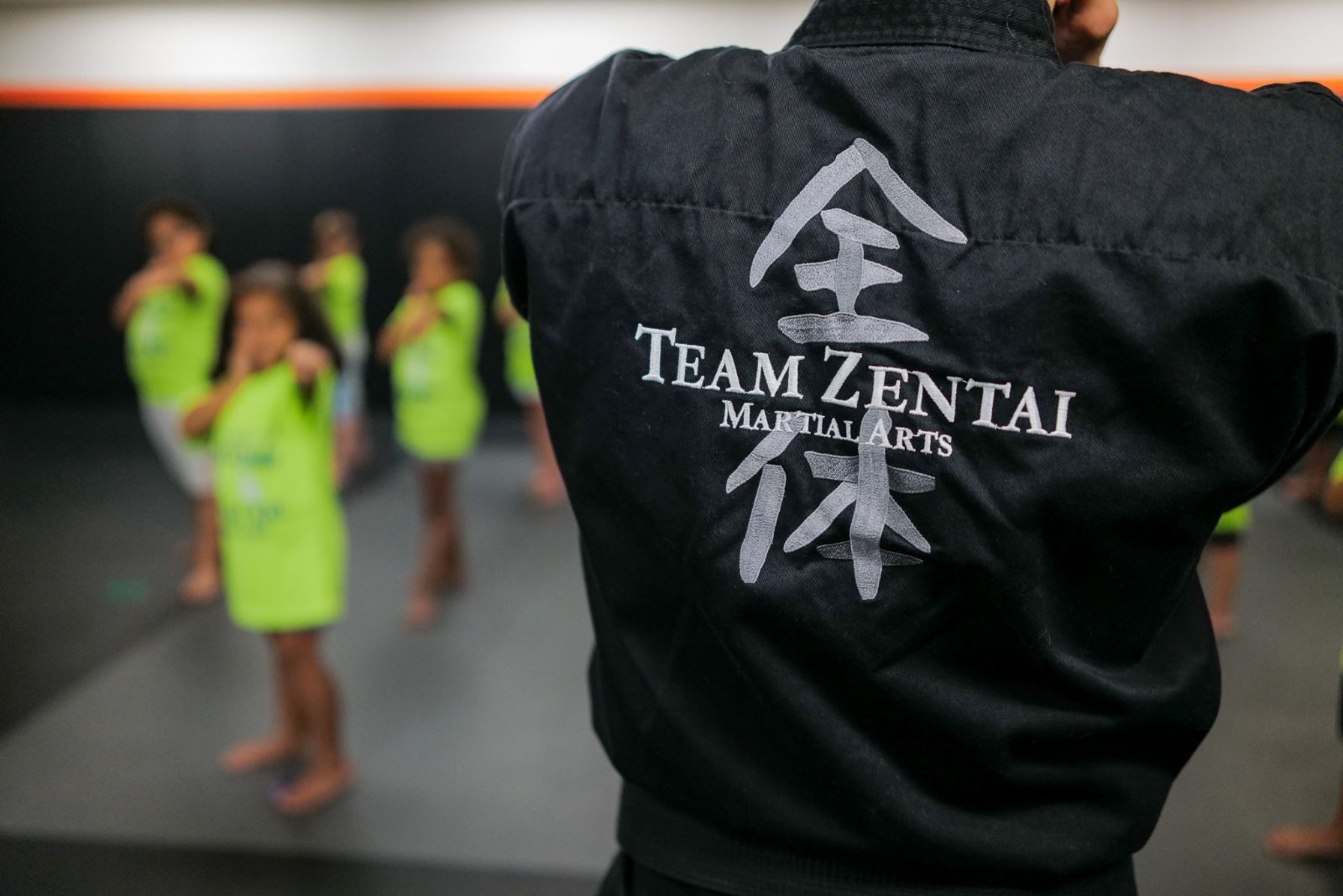Instructor in a Team ZENTAI jacket leading campers at ZENTAI summer camp in New Jersey