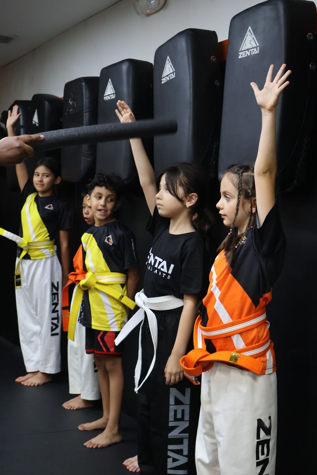 Kids raising foam noodles in a game at ZENTAI Martial Arts in North Arlington, NJ