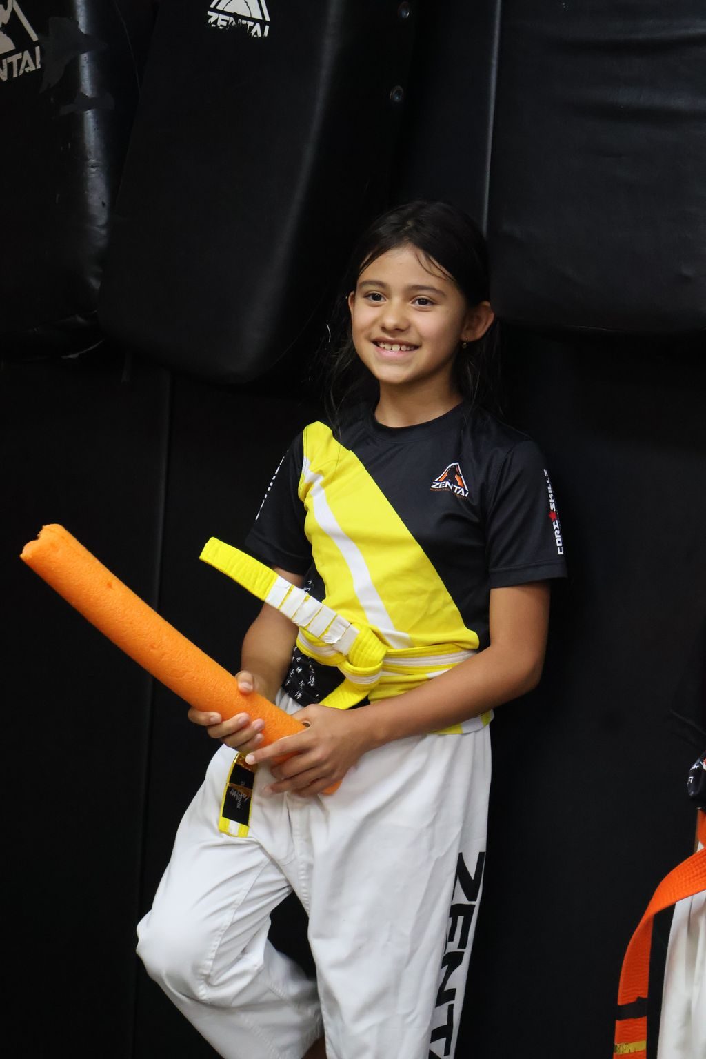 Girl smiling with foam noodles at ZENTAI Martial Arts in North Arlington, NJ