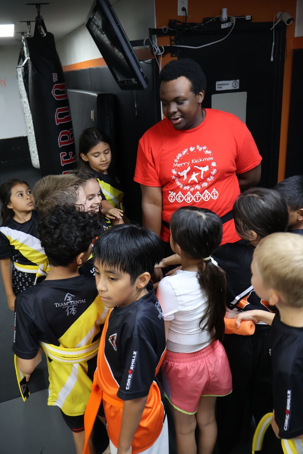 Instructor talking with kids gathered around him at ZENTAI Martial Arts in North Arlington, NJ