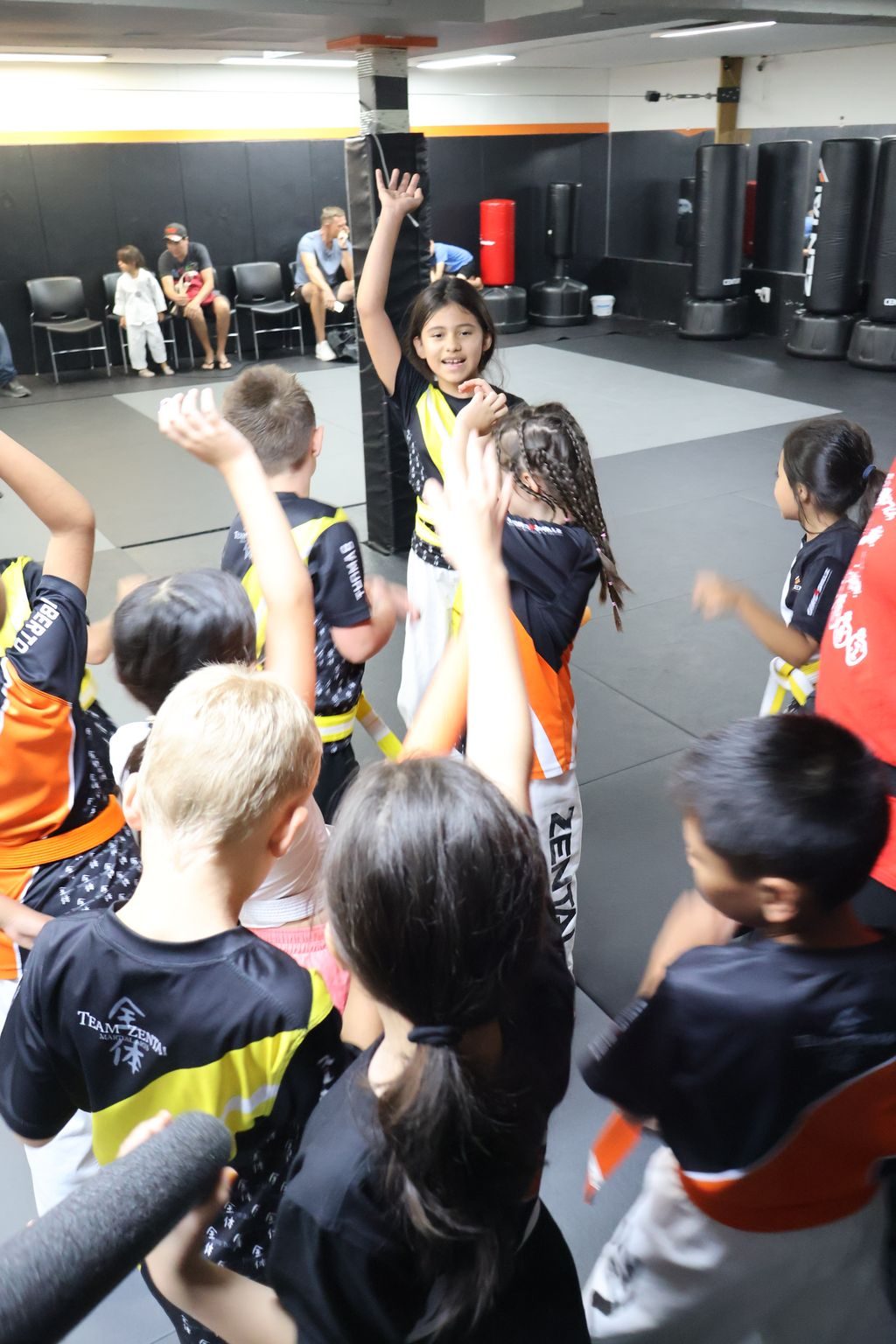 Kids raising their hands together at ZENTAI Martial Arts in North Arlington, NJ