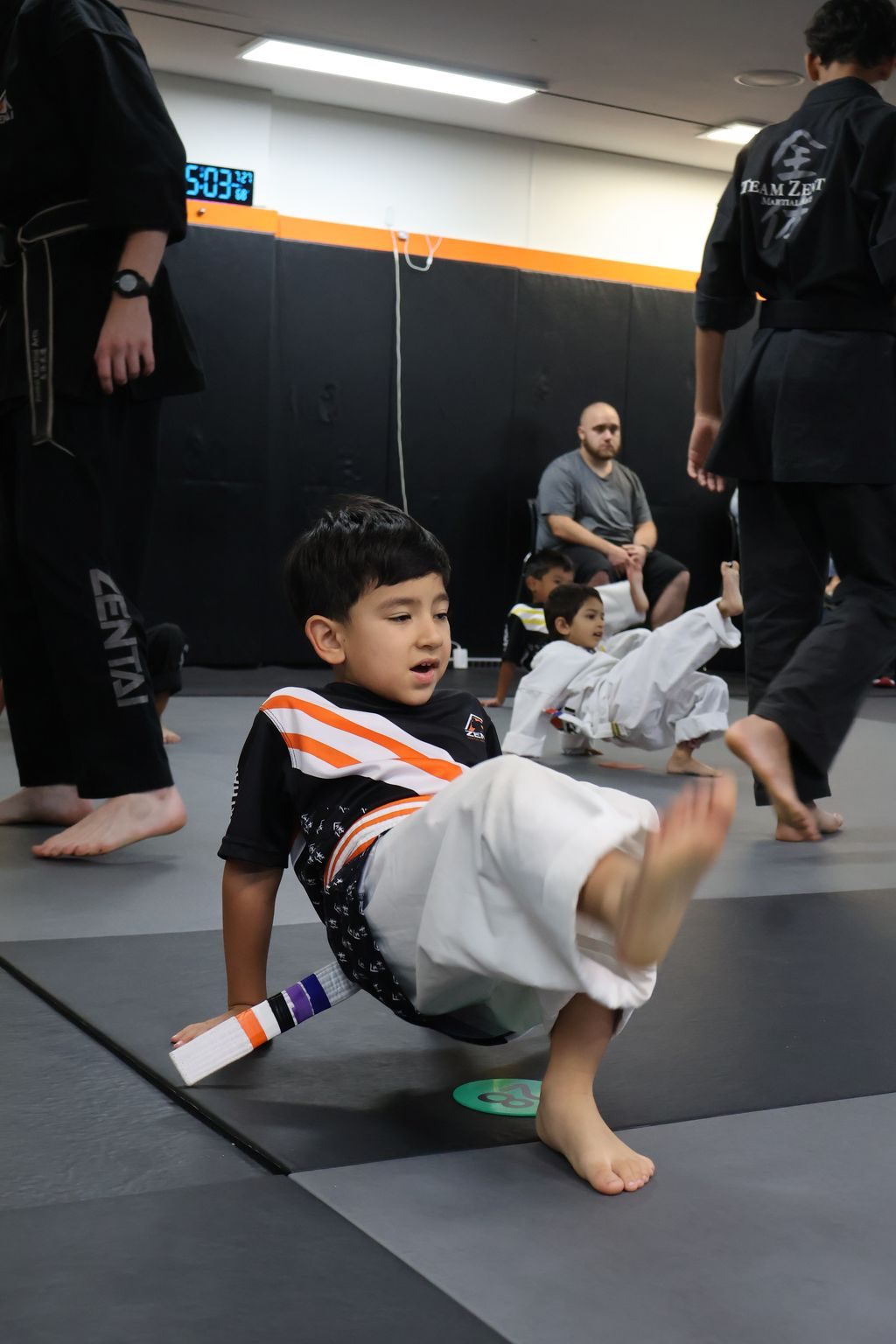 Boy practicing a roll on the mat at ZENTAI Martial Arts in North Arlington, NJ