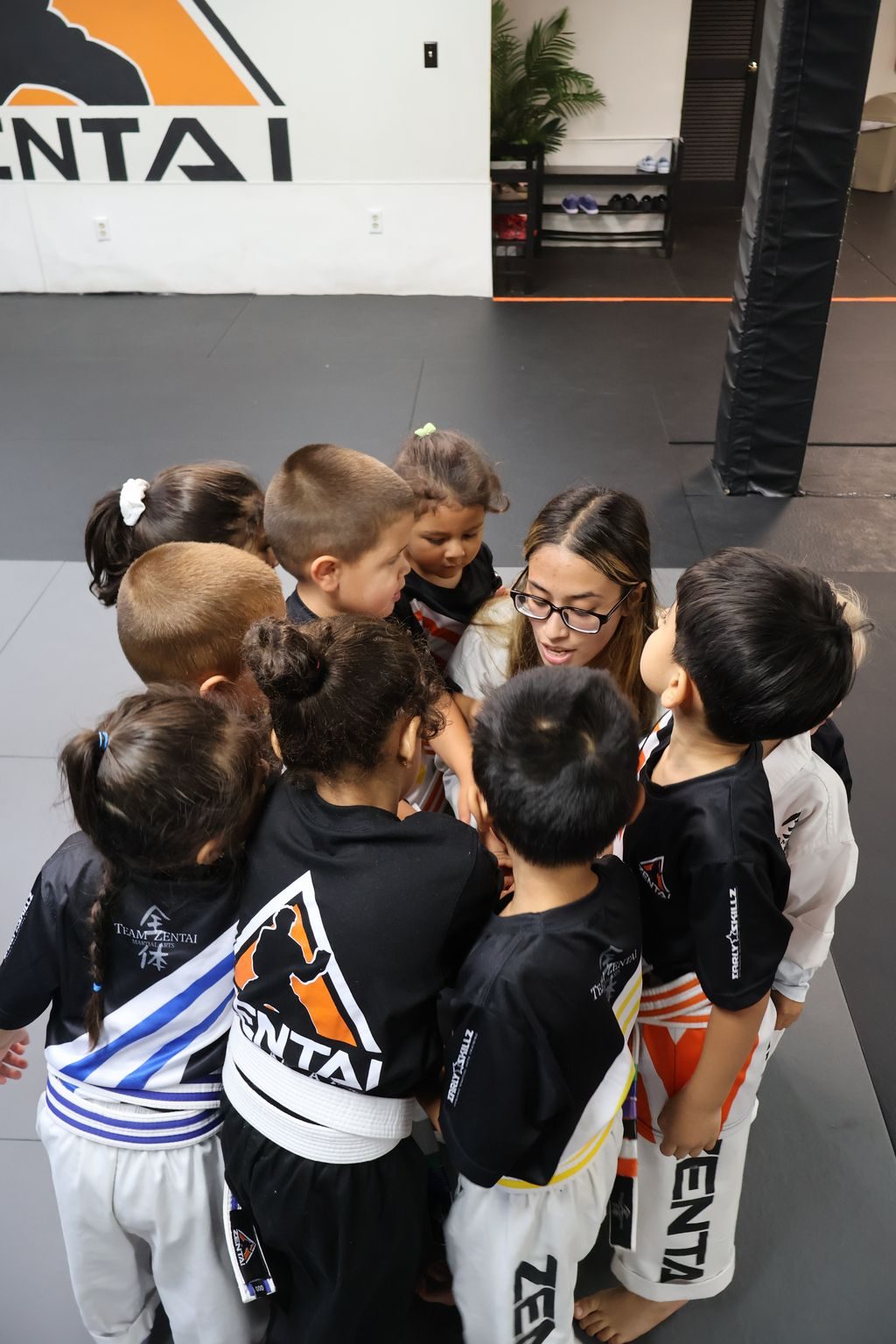 Kids in a team huddle at ZENTAI Martial Arts in North Arlington, NJ