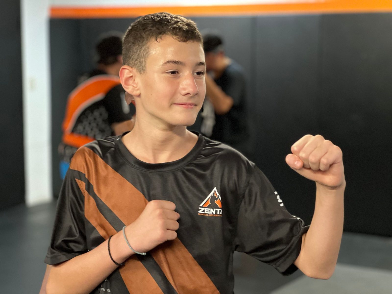 Teen smiling with fists up at ZENTAI Martial Arts in New Jersey